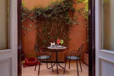 a table and chairs sitting on a patio at Grand Hotel Plaza in Rome