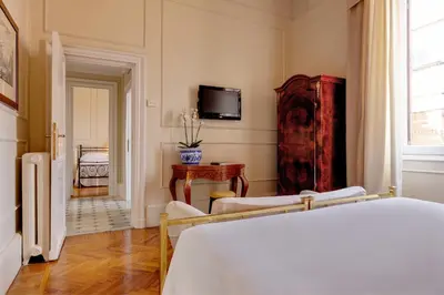 a room with a bed and a tv on the wall at Grand Hotel Plaza in Rome