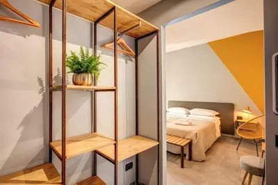 a room with a bed and a room with a book shelf at Hotel King in Rome
