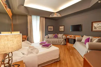 a living room with a bed and a couch at Hotel Isa in Rome