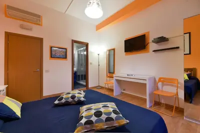 a bedroom with a bed and a desk and a television at Barbara Vaticano Affitti Brevi in Rome