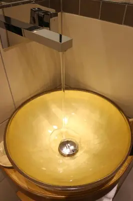 a bathroom with a sink with a light on it at Magenta Pantheon Navona in Rome
