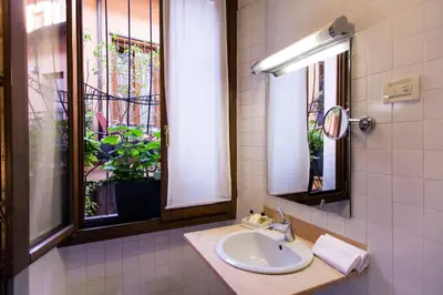 a bathroom with a sink and a window at Hotel Columbia in Rome