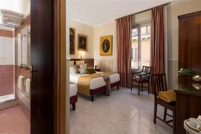 a hotel room with a bed and a bathroom at Hotel Des Artistes Roma in Rome