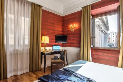 a hotel room with a bed and a desk with a computer at Albergo del Senato in Rome