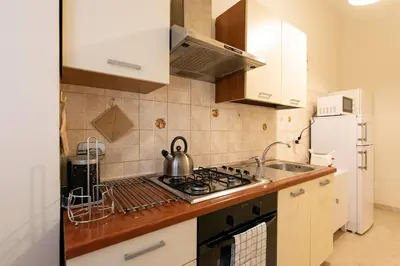 a kitchen with a sink and a stove top oven at Giulio Cesare Imperatore in Rome