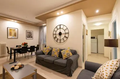 a living room with a couch and a dining room at Giulio Cesare Imperatore in Rome