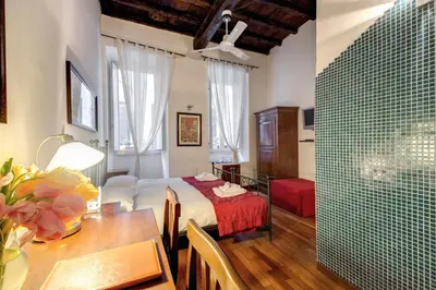 a room with a bed and a table with a dining room at Nova Domizia in Rome