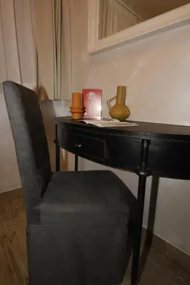 a black desk with a chair and a table with a chair at Dulcis In Pantheon in Rome