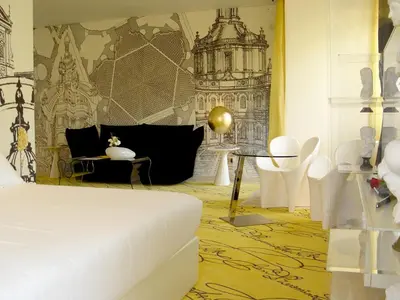 a bedroom with a bed and chairs and a table at Hotel Ripa Roma in Rome