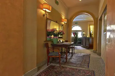 a hallway with a table and chairs in a house at Hotel Silva in Rome