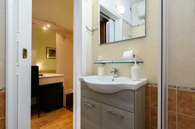 a bathroom with a sink and a mirror at Hotel Julia Trevi - Spagna in Rome
