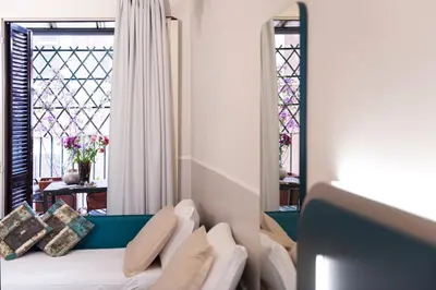 a bedroom with a bed and a window with a view at Hotel Grifo in Rome