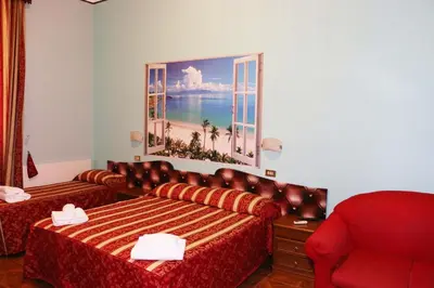 a hotel room with a bed and a picture of the ocean at Hotel Gabriele in Rome