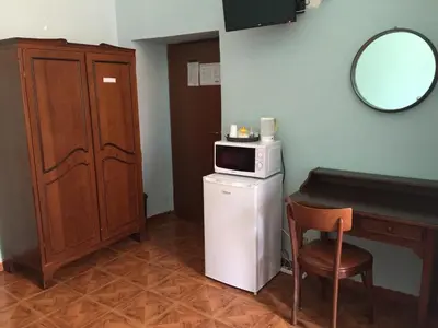 a small room with a table and a microwave at Hotel Gabriele in Rome