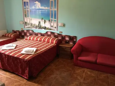 a hotel room with a bed and a chair at Hotel Gabriele in Rome