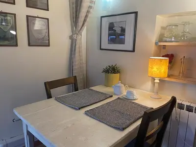 a dining room table with two chairs and a lamp at Boutique Grifone in Rome