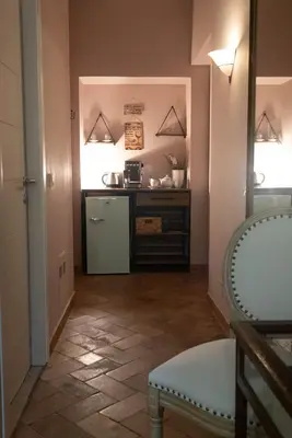 a kitchen with a refrigerator and a counter at Boutique Grifone in Rome