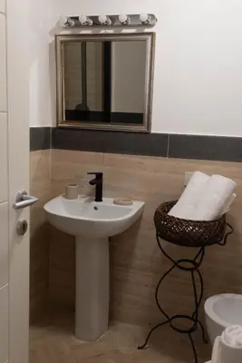 a bathroom with a sink and a mirror and a stool at Boutique Grifone in Rome