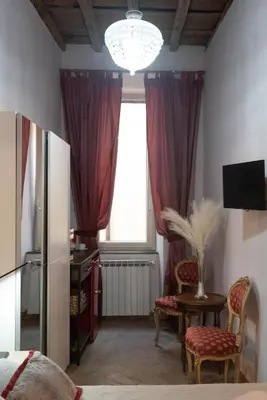 a living room with a window and a table with chairs at Boutique Grifone in Rome