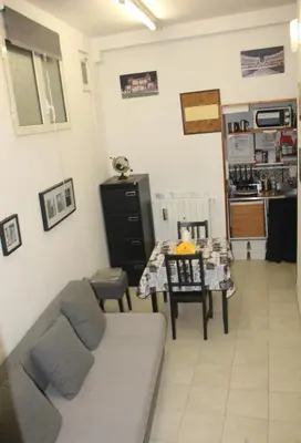 a living room with a couch and a table at Mini Suite Indipendente in Rome