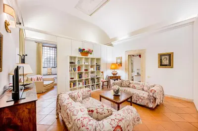 a living room with two couches and a tv at Palazzo Donarelli in Rome