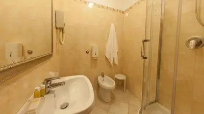 a bathroom with a sink and a shower and a toilet at Dama Private Rooms in Rome