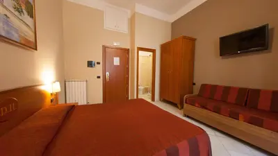 a hotel room with a bed and a couch at Dama Private Rooms in Rome