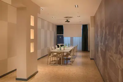 a long dining room with a long table and chairs at NH Roma Villa Carpegna in Rome