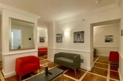 a waiting room with a chair and a mirror at BB Hotels Smarthotel Bailey's in Rome