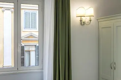 a room with a window and a green curtain at BB Hotels Smarthotel Bailey's in Rome