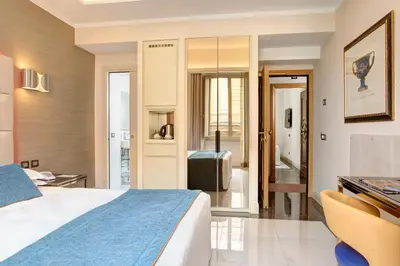 a hotel room with a bed and a bathroom at Marcella Royal Hotel - Rooftop Garden in Rome