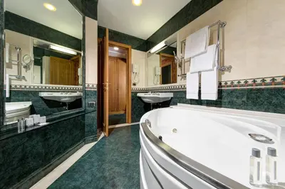 a bathroom with two sinks and a bath tub at Marcella Royal Hotel - Rooftop Garden in Rome
