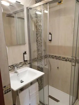 a bathroom with a sink and a toilet and a window at Hotel Bolivar in Rome