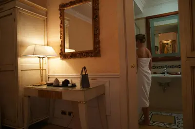 a woman in a bathroom with a sink and a mirror at Hotel Bolivar in Rome