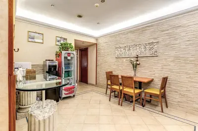 a kitchen and dining room with a table and chairs at Hotel Orlanda in Rome