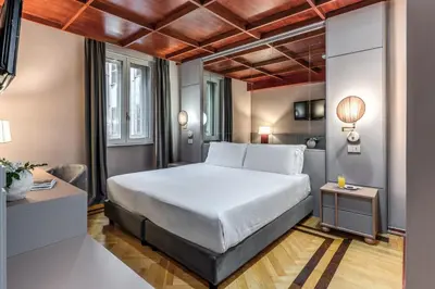 a hotel room with a bed and a desk at Madison Hotel in Rome