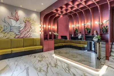 a lobby of a hotel with pink walls at Madison Hotel in Rome