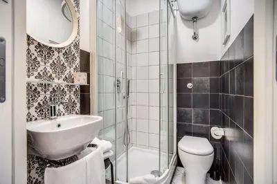 a bathroom with a sink and a toilet and a shower at Hotel Seiler in Rome