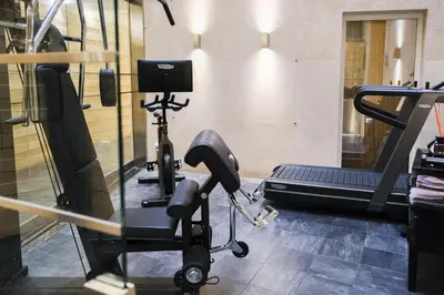 a gym with a treadmill and a exercise bike at Stendhal Hotel in Rome
