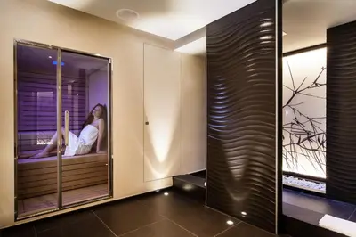 a woman sitting on a window sill in a room at Baglioni Hotel Regina - The Leading Hotels of the World in Rome