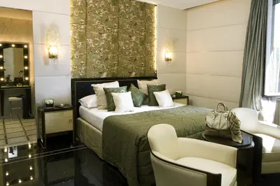 a hotel room with a bed and a chair at Baglioni Hotel Regina - The Leading Hotels of the World in Rome