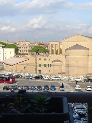 a parking lot with cars parked in a parking lot at Quartopiano Guesthouse in Rome