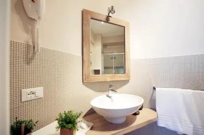 a bathroom with a sink and a mirror at Quartopiano Guesthouse in Rome