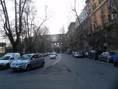 a street with cars parked on the side of the road at Vesta Domus in Rome