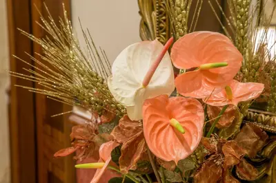 a vase filled with flowers in front of a mirror at Hotel Forte in Rome