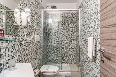 a bathroom with a shower with a toilet and a sink at Hotel Centro Cavour Roma in Rome