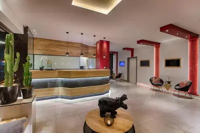 a lobby with a cow statue on a table at Hotel Raganelli in Rome