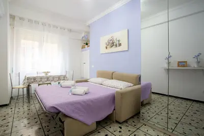 a bedroom with a bed with a purple blanket at Vatican Station in Rome