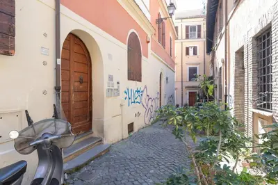 a bike parked next to a building with graffiti at Nostromondo Ciancaleoni Palace in Rome